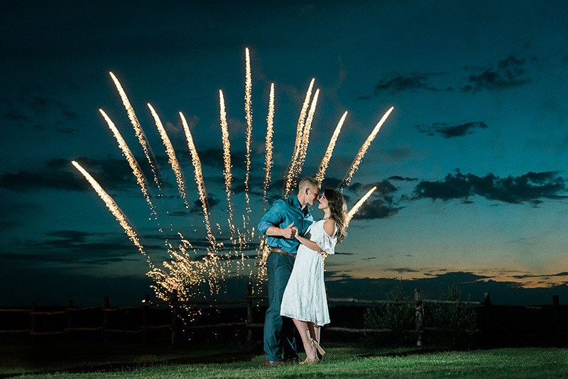 Couple dancing in front of fireworks